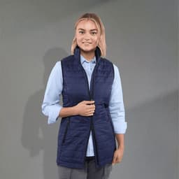 A navy insulated puffer vest with a zip front and side pockets, worn over a light blue shirt.