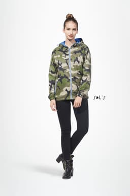 A unisex hoodie in camouflage pattern, featuring a hood and zip closure, paired with black skinny pants and boots.