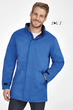 A man wearing a blue unisex jacket with a fleece-lined collar and a logo.