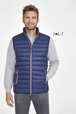 A navy lightweight puffer vest with pink detailing, featuring a zip front and side pockets. It has a branding logo.
