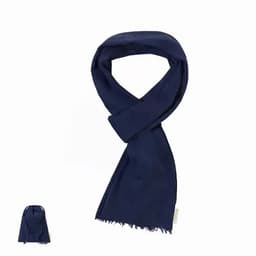 A navy scarf displayed with a matching pouch. The scarf is soft and features a fringed edge.