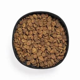 A black bowl filled with brown pet food kibble, featuring assorted shapes and sizes.