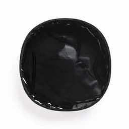 A round, black, glossy container with a smooth interior and a fabric border. It has an overall sleek appearance.