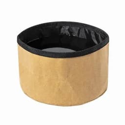 A round container in a tan colour with a black lining and trim, featuring a simple design and no visible branding.