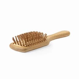 A wooden hairbrush featuring a rectangular shape with bamboo bristles and a smooth handle.