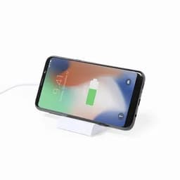 A smartphone on a white charging stand, displaying a battery charging icon on its screen.