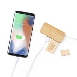 A wireless charger with a bamboo top and wooden base, connected to a smartphone displaying a charging icon.