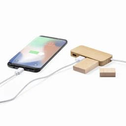 A wooden phone charger and a smartphone are connected via a charging cable. The charger features a minimalist design.