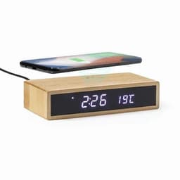 A wooden alarm clock with a digital display showing the time and temperature, with a smartphone placed above it.