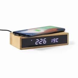A wooden clock with a charging pad on top, displaying the time and temperature in digital format.