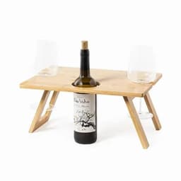 A bamboo table set with a wine bottle in the centre and two wine glasses on each side.
