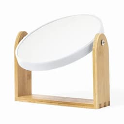 A desktop mirror with a round, white reflective surface and a wooden bamboo frame.