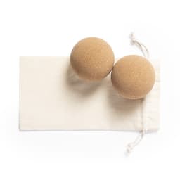 Two brown cork balls placed on a natural fabric pouch.