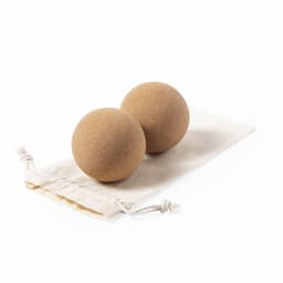 Two brown massage balls on a fabric pouch. The pouch features a drawstring closure.