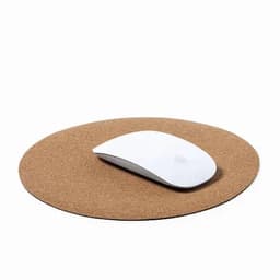 A round cork mouse pad with a white computer mouse resting on it. The surface is natural brown cork.