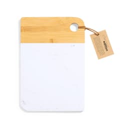 A cutting board with a bamboo handle and a white marble surface, featuring a tag attached for details.