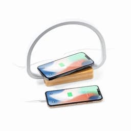 A wireless phone charger with a wooden base and a flexible light, featuring two smartphones charging.