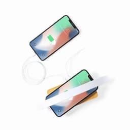 A wireless charging pad in a natural wood finish, powering two smartphones with white cables.