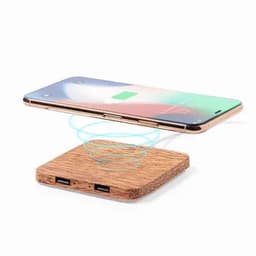 A wireless charging pad made from wood with two USB ports, along with a smartphone hovering above it.