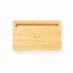 A bamboo cutting board with a groove along one edge and a subtle logo in the centre. Natural wood colour.