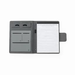 A grey organiser folder with two card slots, a pen holder, and a pad of lined paper inside. It features a logo.