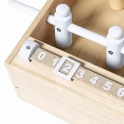 A wooden counting game featuring a white number dial and wooden pegs in a natural wood box. Includes branding.