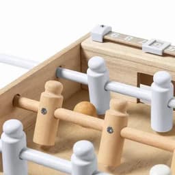 A wooden tabletop game featuring white and natural timber players, with a ball and a score counter.