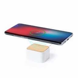 A wireless phone charger with a wooden top and white base, showcasing a smartphone being charged above it.