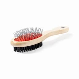 A hairbrush with a wooden handle, featuring metal bristles on one side and soft bristles in black on the other side.