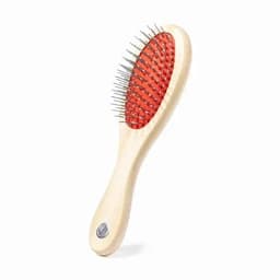 A hairbrush with a wooden handle and red bristles, featuring metal pins for detangling hair.