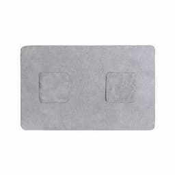 A grey bath mat with two textured square patches on the surface and rounded edges. It features a soft, plush design.