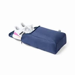 A storage pouch in navy blue, designed to hold a pair of shoes, featuring a zip closure.