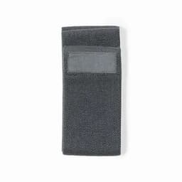 A grey towel with a textured pattern, folded neatly. It features a small pocket on one side and includes a logo.