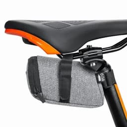A bike seat bag in grey fabric, secured under a black bike seat, featuring an orange accent. It has a zip closure.