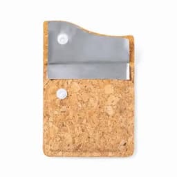 A cork wallet with a metallic flap and two snap buttons. It features a natural cork texture.