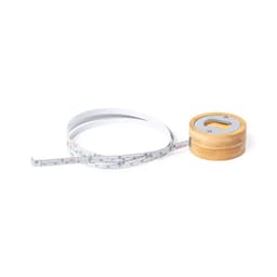A measuring tape with a white body and a wooden spool, coiled next to it. The tape features standard measurements.