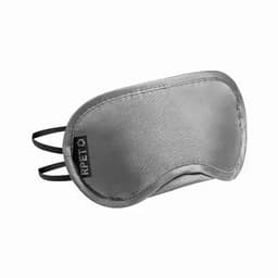 A sleep mask in grey with elastic straps and a logo. The material has a smooth texture.