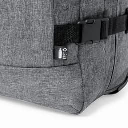 A grey backpack with a textured surface and a side buckle strap. Features a small logo.
