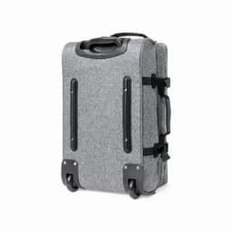 A grey suitcase with wheels, featuring a textured fabric surface and adjustable straps. It has a handle for easy transport.