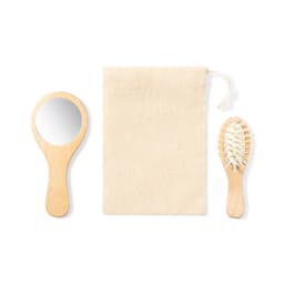 A wooden hairbrush, a handheld mirror, and a natural fabric pouch feature in the image.