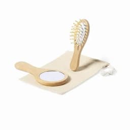A wooden hairbrush and mirror set on a light-coloured fabric pouch. The brush has a natural finish.