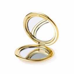 A gold compact mirror with a shiny finish, opened to reveal two reflective surfaces inside.