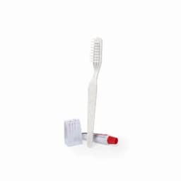 A dental kit featuring a white toothbrush, red toothpaste tube, and a white pencil sharpener.