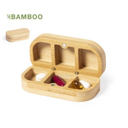 A bamboo pill organiser with three compartments, featuring white, red, and yellow capsules inside. It has a branded logo.