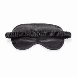 A sleep mask in black satin with a soft, gathered elastic band for comfort. Features a smooth texture and a classic design.