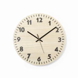 A wall clock with a light wooden finish, black numbers, and hands, featuring a minimalist design.
