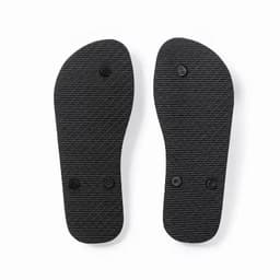 A pair of black flip flop soles with a textured surface and two circular bumps on each sole.