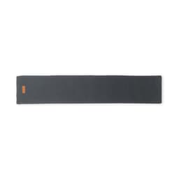 A grey yoga mat with a smooth texture and an orange logo on one end.