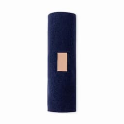 A yoga mat in navy blue with a textured surface and a rectangular patch. It has a simple, modern design.