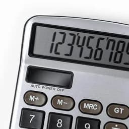A calculator with a silver body and large digital display, featuring numbers 0-9 and various function buttons.